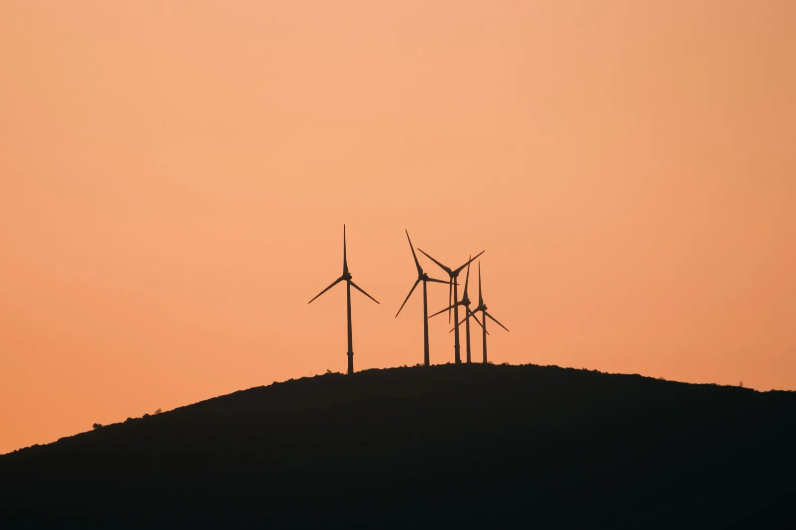 Wind turbines on a ridge at sunset
